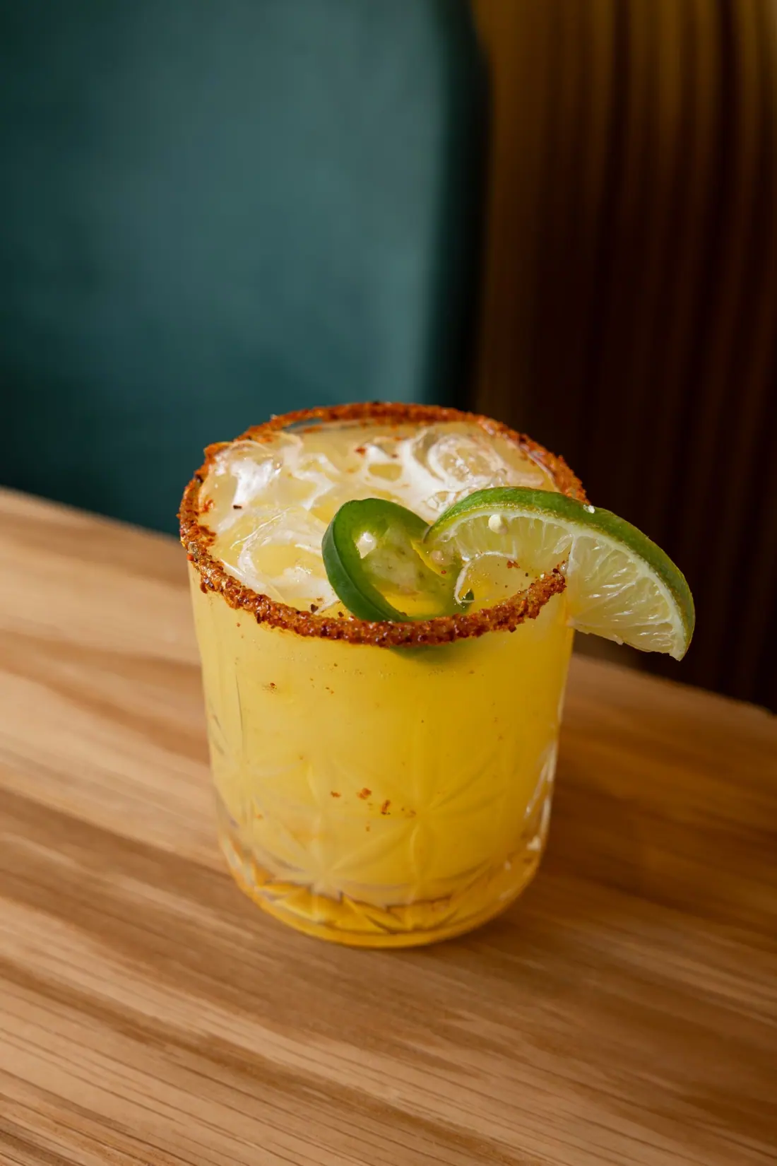 A spicy margarita with a Tajín rim